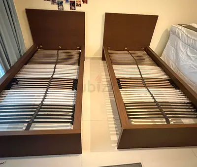 Pair of single wooden bed frames with slatted bases - good condition