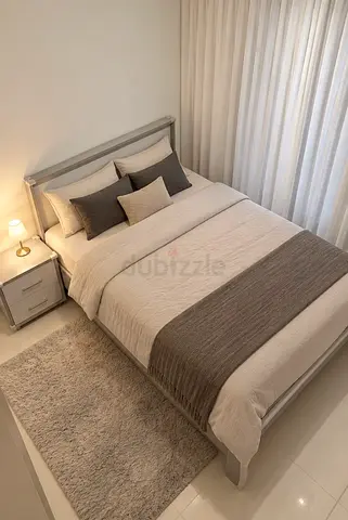 Queen bed with bedside table and neutral bedding set