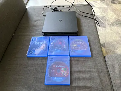 PlayStation 4 Slim console with 4 PS4 game discs and power cable