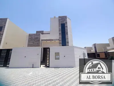 For sale: Corner villa in Al Helio 2, Ajman, consisting of 4 master bedrooms, a majlis, a living room, a spacious kitchen, and a maid's room.