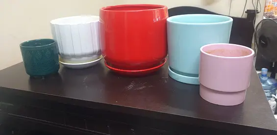 Set of 5 assorted ceramic plant pots with saucers - various sizes and colors