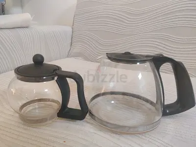 Two glass kettle/coffee pots with black handles - good condition