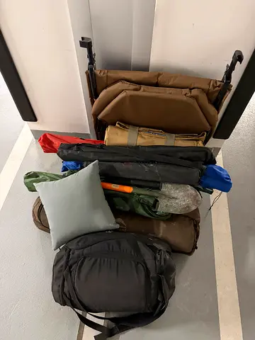 Used fishing gear collection — rods, carrying bag, chair and accessories
