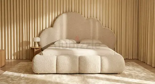 Cream upholstered queen bed with cloud headboard and padded base