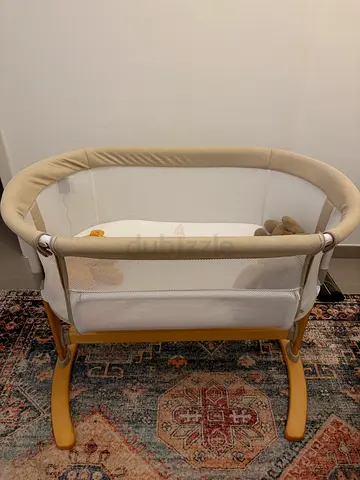 beige baby bassinet with mattress and liners — good condition