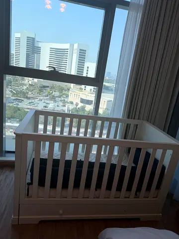 White wooden baby crib with under-drawer, good condition