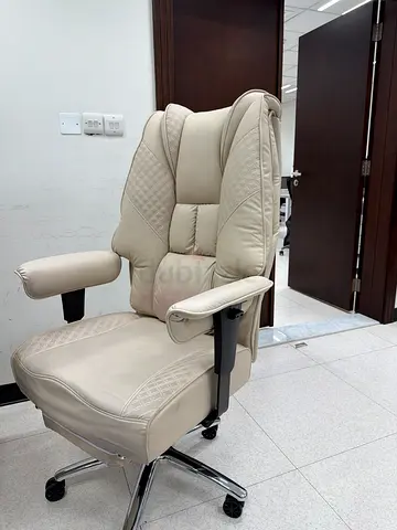 Comfortable beige leather office chair with footrest (adjustable)