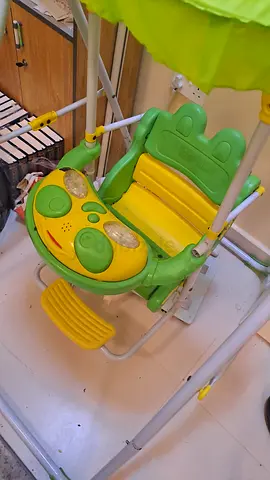 Used baby swing with canopy and toy tray — green/yellow, good condition