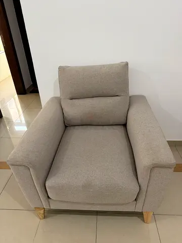 Light beige single armchair with wooden legs - good condition