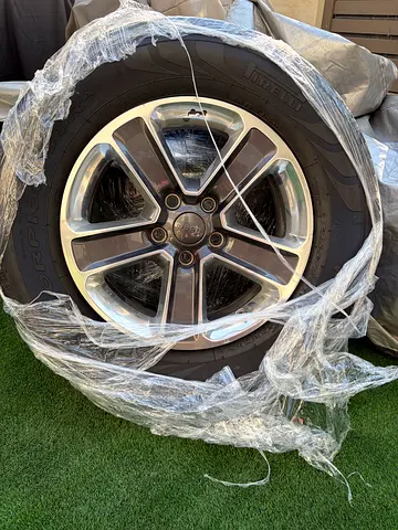 Jeep Wrangler 18 inch original rims & tires.