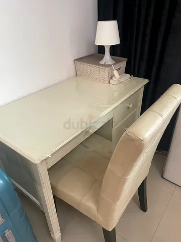 White table with cushioned chair