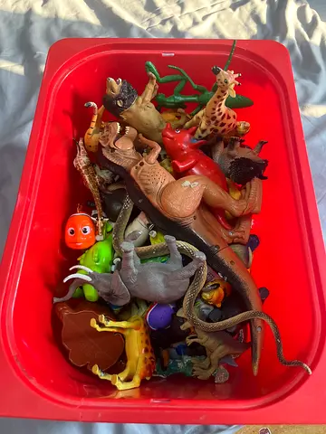 Bin of mixed animal figurines and toy figures - assorted set