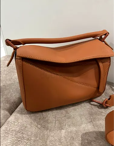 Copy a Brown leather shoulder bag with wide embossed strap