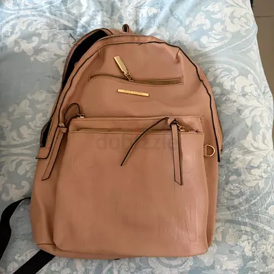 Beige leather-look backpack with front pocket — good condition