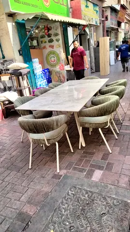 Marble-top dining table with 8 green upholstered chairs - good condition