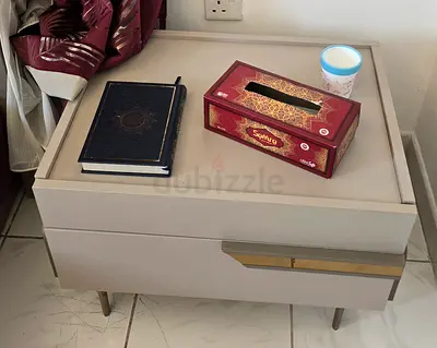 Beige modern bedside nightstand with drawer and brass accent