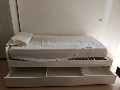 Single white wooden bed with three under-bed storage drawers