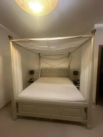 White four-poster canopy bed with mattress - King size. Mattress size 180x210cm included.