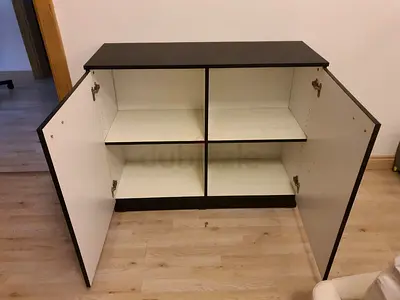 Two-door black & white storage cabinet with shelves - good condition