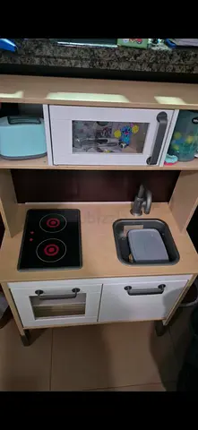 Wooden Play Kitchen Set with Sink and Stove - Good Condition with pots/pans, cutlery, and fake food.