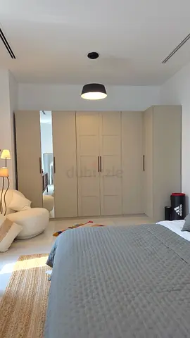 Built-in ikea pax bedroom wardrobe with mirrored panel in grey-beige color