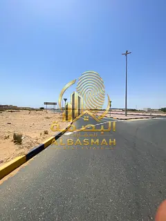 Corner residential plot for sale in the Al-Hoshi area, Sharjah; land area is 10,000 square feet; fre