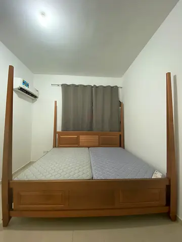 Solid wood king-size bed frame with headboard and footboard