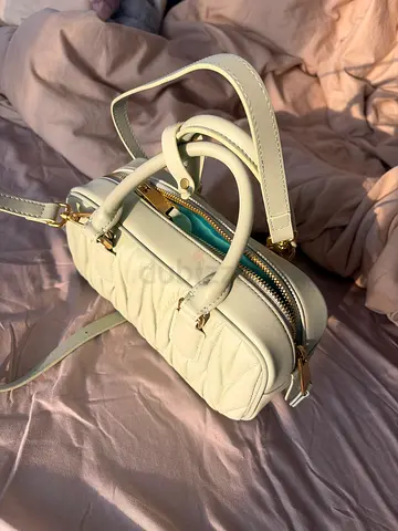White quilted crossbody handbag with gold hardware