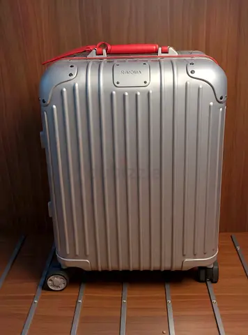 RIMOWA Original
Cabin Twist Suitcase -shell carry-on suitcase with red handles and combo locks