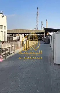 For sale: A compound in Emirates Industrial City featuring three rooms, an open canopy, and an outdo