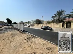 A prime plot of land for sale on a main street in Al-Rawdah 2