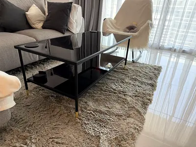 Black glass-top coffee table with lower shelf - pristine condition