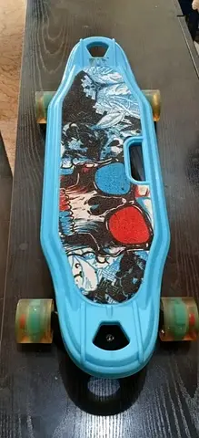 Blue plastic cruiser skateboard with graphic deck - good used condition