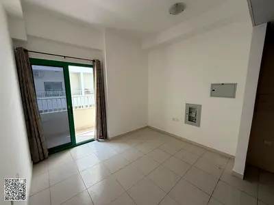 Studio for Annual Rent in Al Aamra – Smart Tower • Studio with Balcony • Separate Kitchen • Central AC • Gym and Swimming Pool • Private Parking • Pr