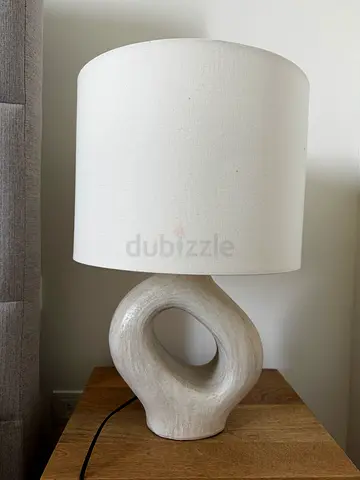 Bloomr ceramic loop table lamp with white drum shade.