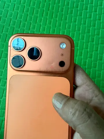 Used iPhone 17 pro max (orange case) with triple camera - good condition. Just a minor dent as show