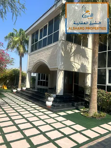 A luxurious villa in the Al-Houshi area featuring five rooms, a garden, and an annex with an outdoor kitchen.