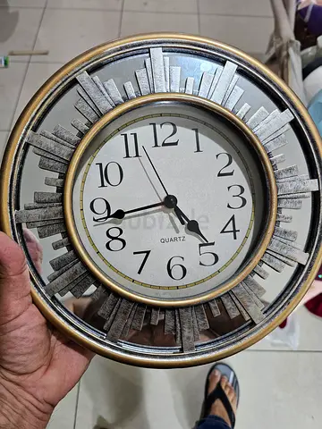 Decorative round wall clock with metallic sunburst frame