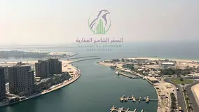 Spacious 2BR master hall in Al Khan with direct sea view, balcony, built-in wardrobes, and hallway.