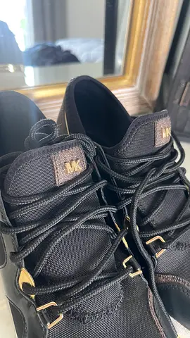 Michael Kors black leather sneakers, size not specified, lightly used