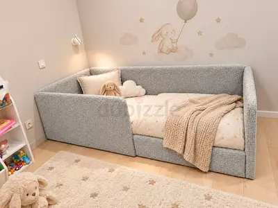 Low-sided toddler bed with soft padded rails — light grey, good condition