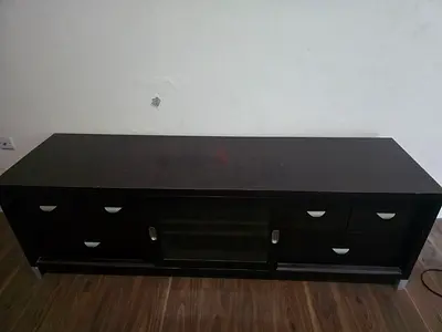 Dark wood TV cabinet with drawers and glass door - good storage