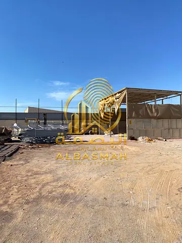 Fenced industrial land for sale in the Al Saja'a area, Sharjah; available for ownership by UAE and GCC nationals.