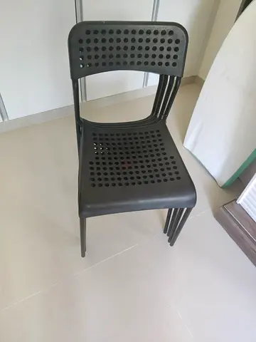 Set of 4 black plastic stacking chairs - used, good condition