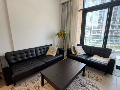 Black leather sofa set - 2-seater, 3-seater and adjustable table in very good condition