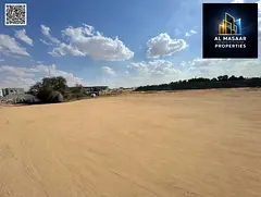 Residential land for sale on a main road, featuring a large setback and a prime location in the Al H
