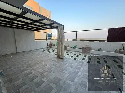 Two master bedrooms, a large living area, central air conditioning, a balcony with an open view, a spacious rooftop terrace, a maid's room, a large k