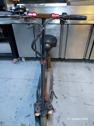 Used adult kick scooter with dual front lights and folding frame