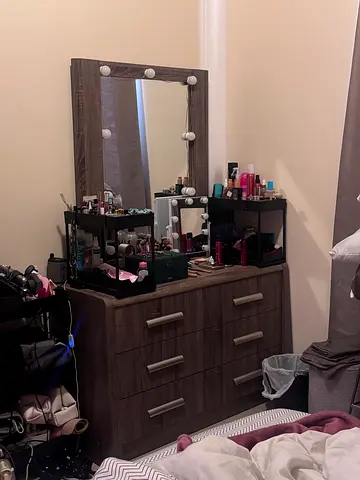 Dark wood dresser with mirror and multiple drawers
