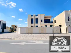 For sale: Corner villa on two streets in Al Helio 2, Ajman. Features 4 master bedrooms, 2 living roo